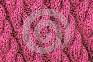 Closeup of pink cable stitch knitting