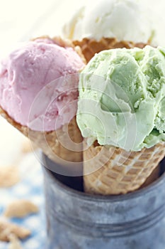 Closeup of pink and green ice cream cones