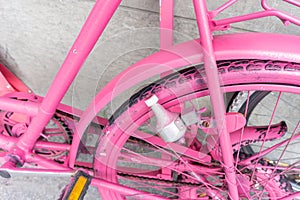 Closeup pink spay painted old bicycle