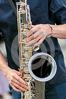 A closeup plane of saxophone player in black shirt