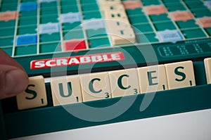 Closeup of plastic letters with word success on Scrabble board game