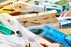Closeup of plastic and wooden clothespins in a basket