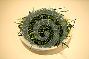 Closeup of a plate of agretti, or salsola soda, raw ready to be cooked photo