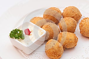 Closeup of a plate with croquetas, spanish croquettes, on a set table photo