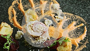 Closeup plate with fish rolls decorated with garnish spinning around