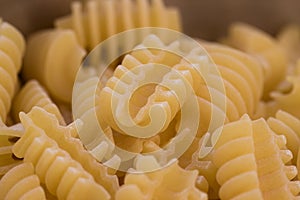 Closeup of a plate with raw italian pasta in the form of radiatori