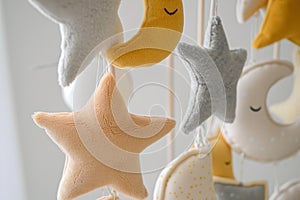 closeup of plush stars and moons on a nursery mobile
