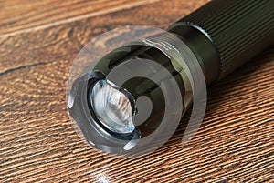 Closeup pocket LED flashlight on dark background