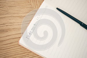 Closeup, podcast and book for write with pen for idea with mockup for mobile app, online or streaming. Writing, plan or
