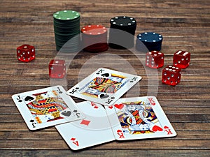 Closeup of poker cards, poker chips and dice on a wooden table