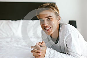 Closeup portrait of a 16 years old teenage guy wearing dental braces