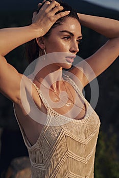 Closeup portrait of an adorable, brunette lady wearing boho style clothes