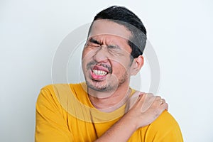 Closeup portrait of Adult Asian man suffer shoulder pain