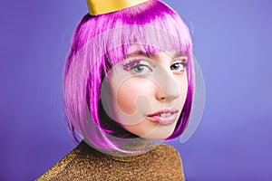 Closeup portrait amazing fashionable young woman with cut purple hair on violet background. Brightful makeup, tinsels