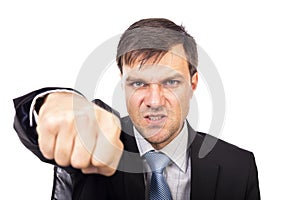 Closeup portrait of an angry businessman threatening with his fist