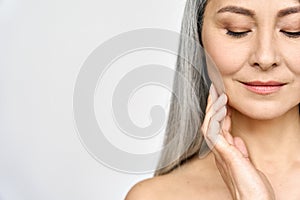 Closeup portrait of Asian mature woman with perfect natural skin.