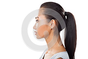 Closeup portrait of Asian young woman in profile with ponytail