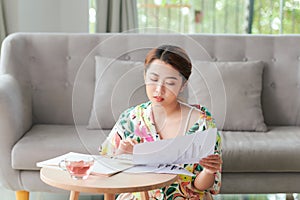 Closeup portrait of attractive young businesslady doing paperwork