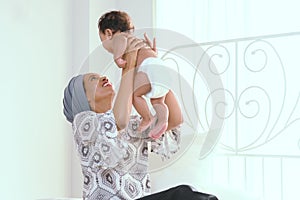 Closeup portrait of beautiful african woman holding on hands her little daughter on white background. Family, love, lifestyle, mot