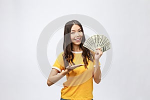 Closeup portrait of beautiful asian woman holding money isolated on white background. Asian girl counting her salary