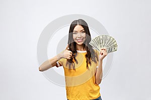 Closeup portrait of beautiful asian woman holding money isolated on white background. Asian girl counting her salary