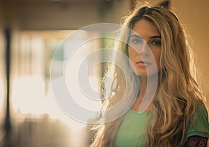 Closeup portrait of a beautiful blonde in a Sunspots corridor.