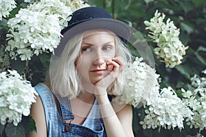 Closeup portrait of beautiful Caucasian teenage young blonde alternative model girl woman in blue tshirt