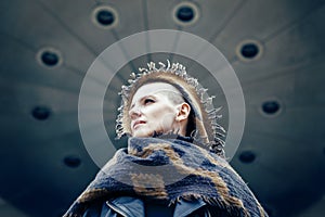 Closeup portrait of beautiful Caucasian white young bald girl woman with shaved hair head in leather jacket and scarf shawl