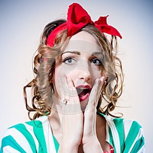 Closeup portrait of beautiful elegant blonde woman with big blue eyes and red lips open mouth in surprise looking at camera