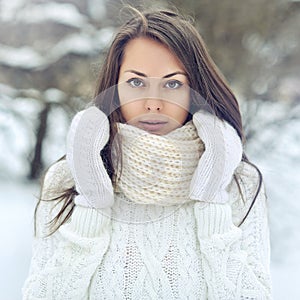 Closeup portrait of a beautiful girl in a winter park