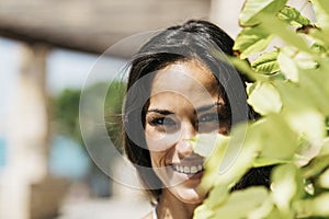 Closeup portrait of a beautiful hispanic woman in blue dress looking camera