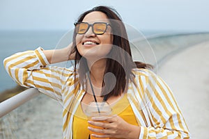 Closeup portrait of beautiful plus size woman 30-35 years old with brunette windy hair feeling freedom and happiness