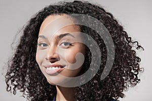 Closeup portrait of beautiful smiling young woman. Laughing joyful cheerful girl close-up studio shot