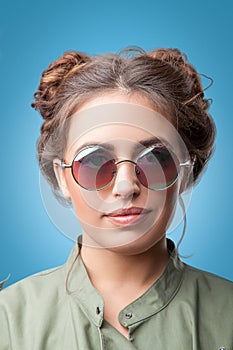 Closeup portrait of beautiful trendy hipster girl with hair buns