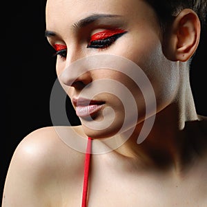 Closeup portrait of beautiful woman with bright make-up and red nails