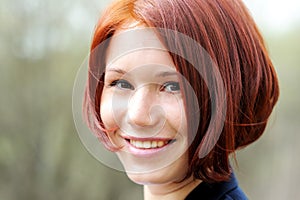 Closeup portrait of beautiful woman with red hair