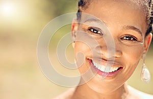 Closeup portrait of a beautiful young African American woman face. Smiling black female showing her healthy teeth and