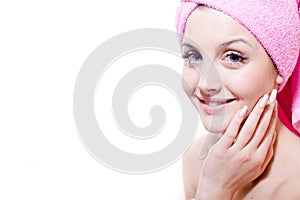 Closeup portrait of beautiful young attractive girl blue eyes blond woman with pink towel happy smiling & looking at camera