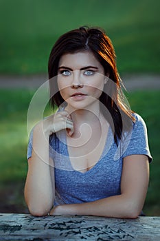 Closeup portrait of beautiful young Caucasian woman with red black hair, blue eyes, looking in camera