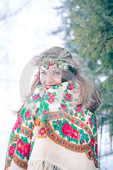 Closeup portrait of beautiful young girl with a traditional Russian or Ukrainian scarf in the winter.