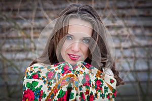 Closeup portrait of beautiful young girl with a traditional Russian or Ukrainian scarf in the winter.