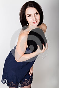 Closeup portrait of beautiful young woman in black hat, posing