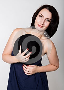 Closeup portrait of beautiful young woman in black hat, posing