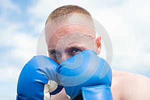 Closeup portrait of boxer practicing punches in boxing. Boxer punching in boxing gloves. Sporty man during boxing