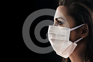 Closeup portrait of a brunette woman wearing a hygienic mask