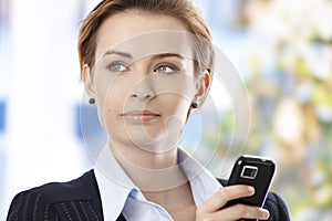Closeup portrait of businesswoman with mobile