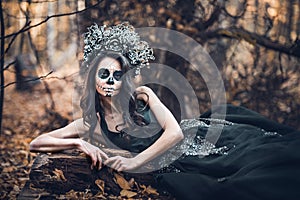 Closeup portrait of Calavera Catrina in black dress. Sugar skull makeup. Dia de los muertos. Day of The Dead. Halloween