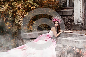 Closeup portrait of Calavera Catrina in pink dress. Sugar skull makeup. Dia de los muertos. Day of The Dead. Halloween