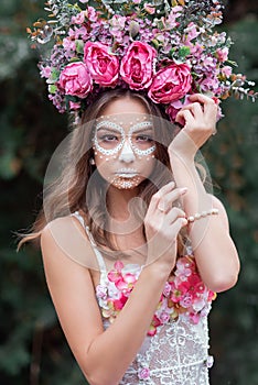 Closeup portrait of Calavera Catrina in pink dress. Sugar skull makeup. Dia de los muertos. Day of The Dead. Halloween