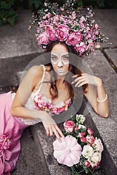 Closeup portrait of Calavera Catrina in pink dress. Sugar skull makeup. Dia de los muertos. Day of The Dead. Halloween